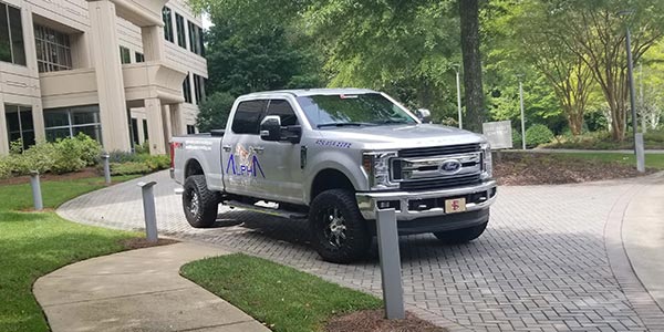 Alpharetta Pressure Washing truck in front of a building